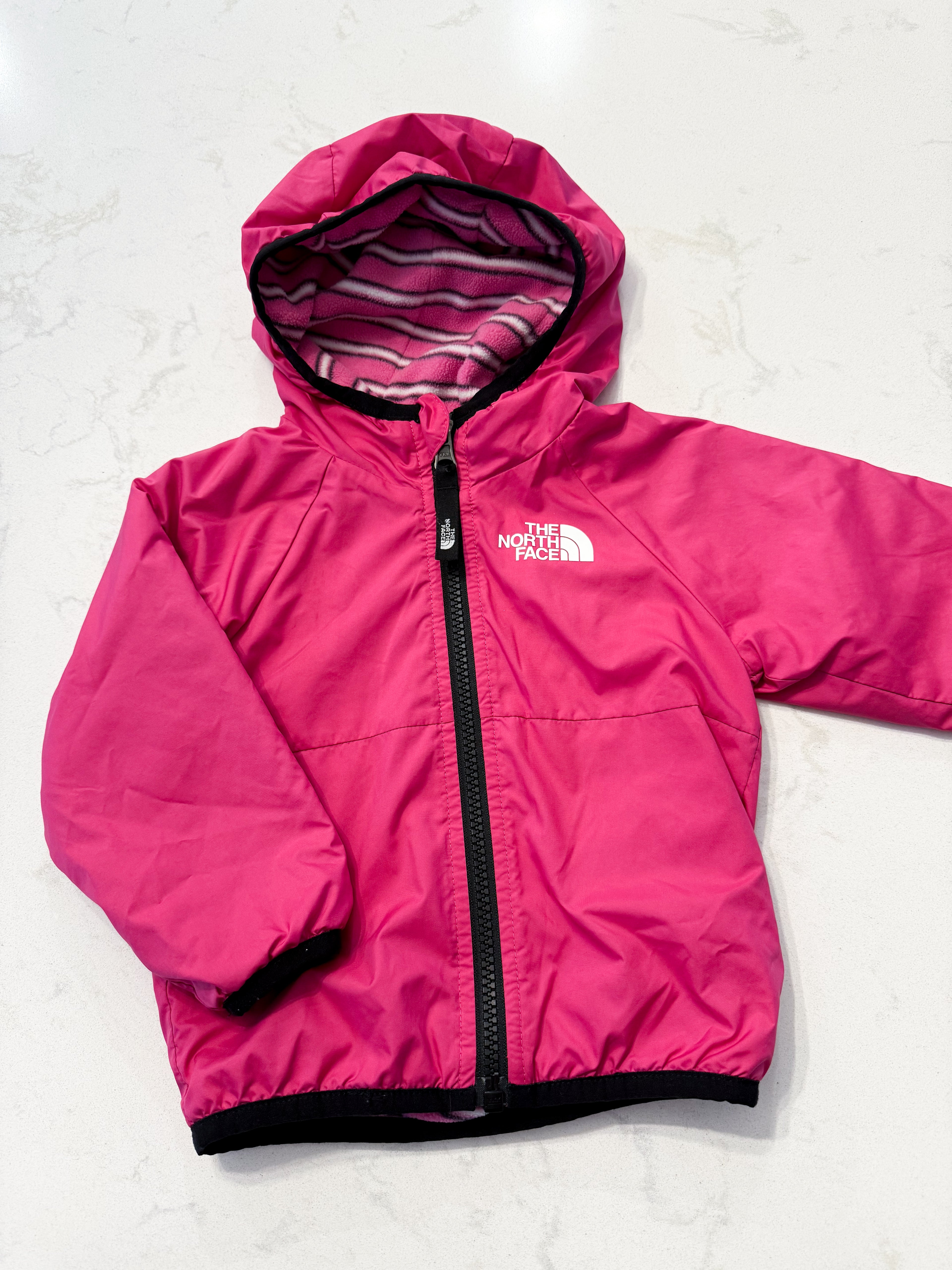 The North Face- 6-12m- VGUC- wind wall reversible bright pink jacket with fleece interior.