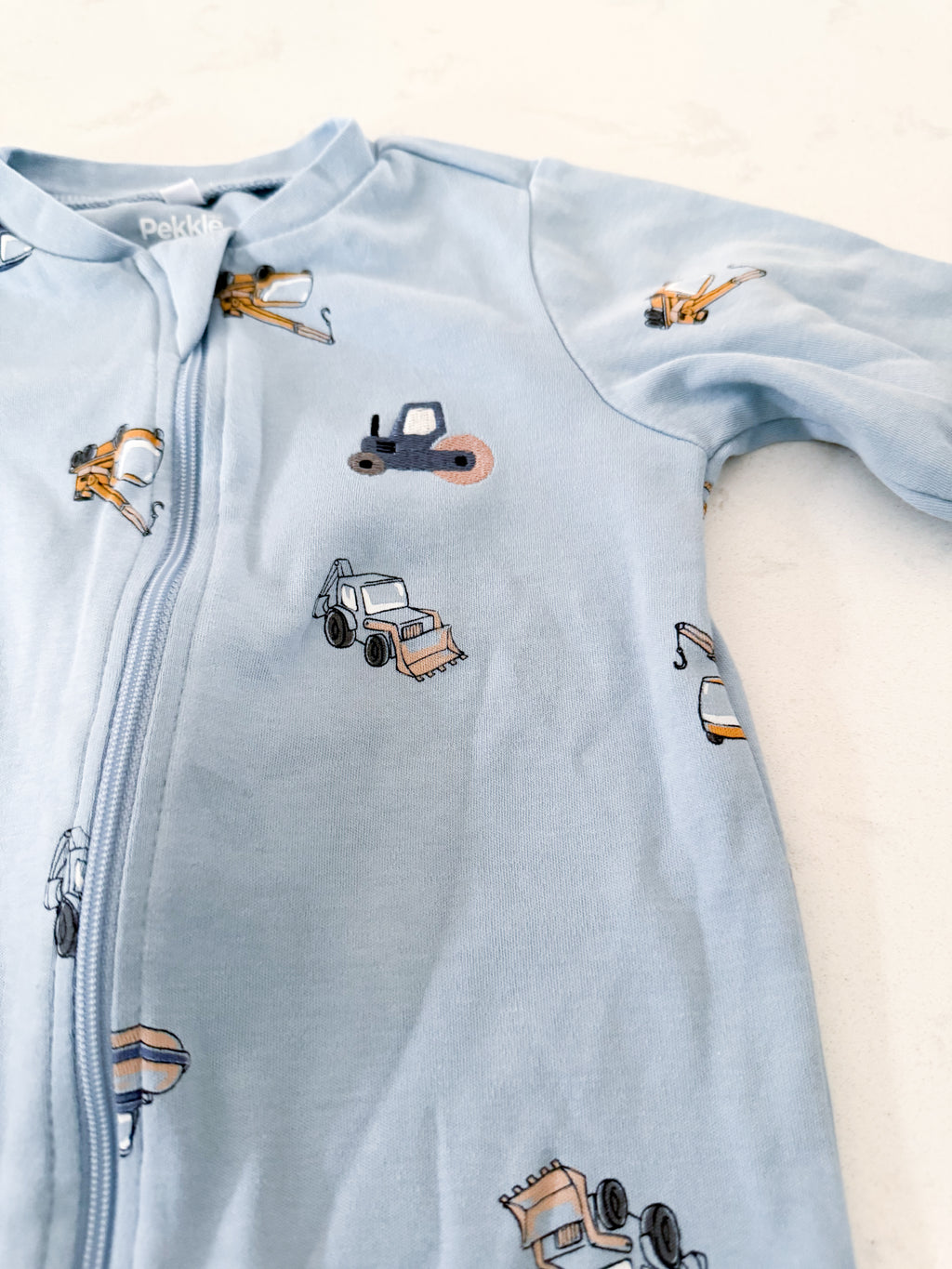 Pekkle- 18m- VGUC- blue zip up jammies with embroidered construction truck