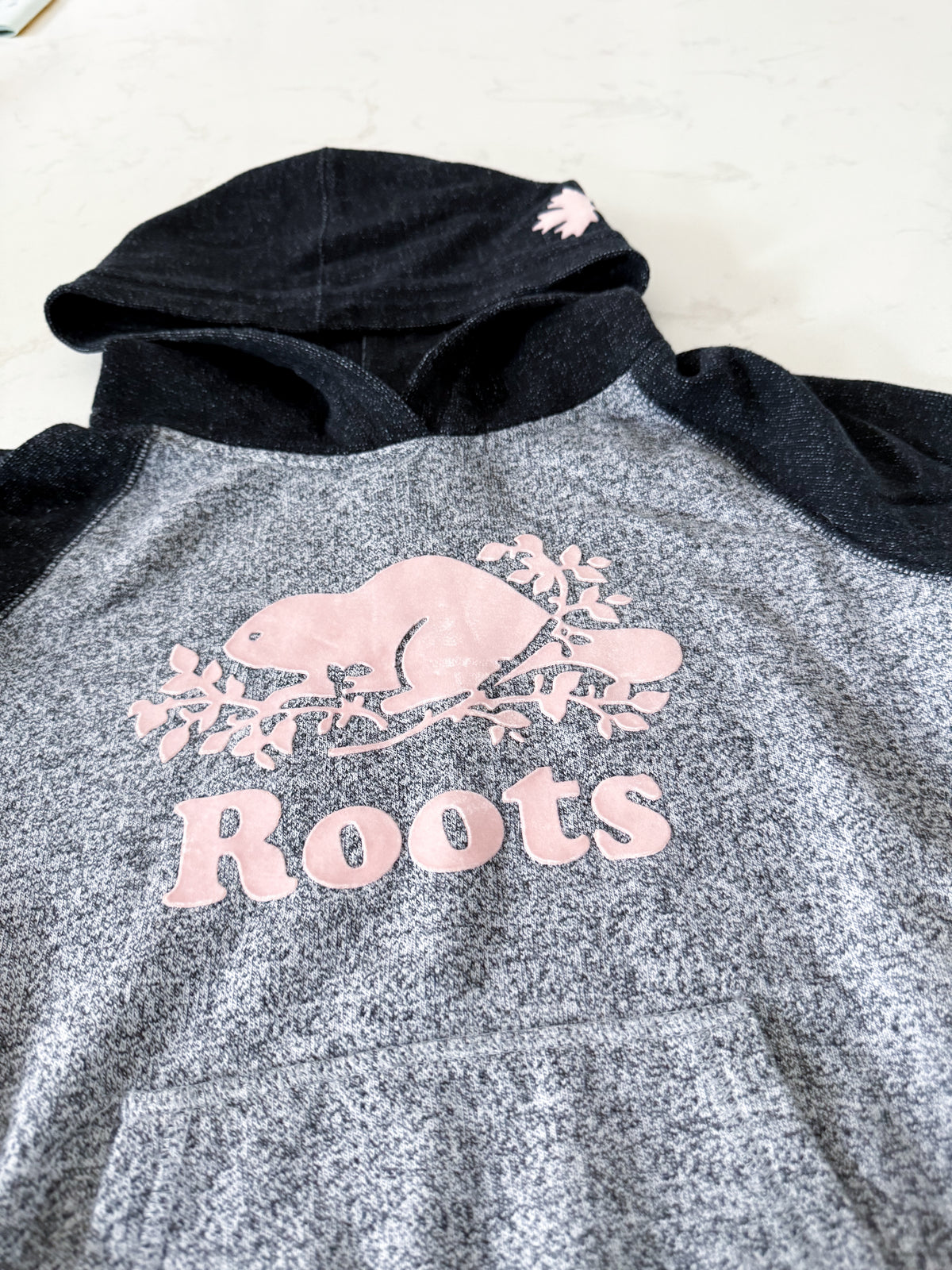 Roots- 11-12Y- VGUC- Grey and black speckled hoodie with pink logo