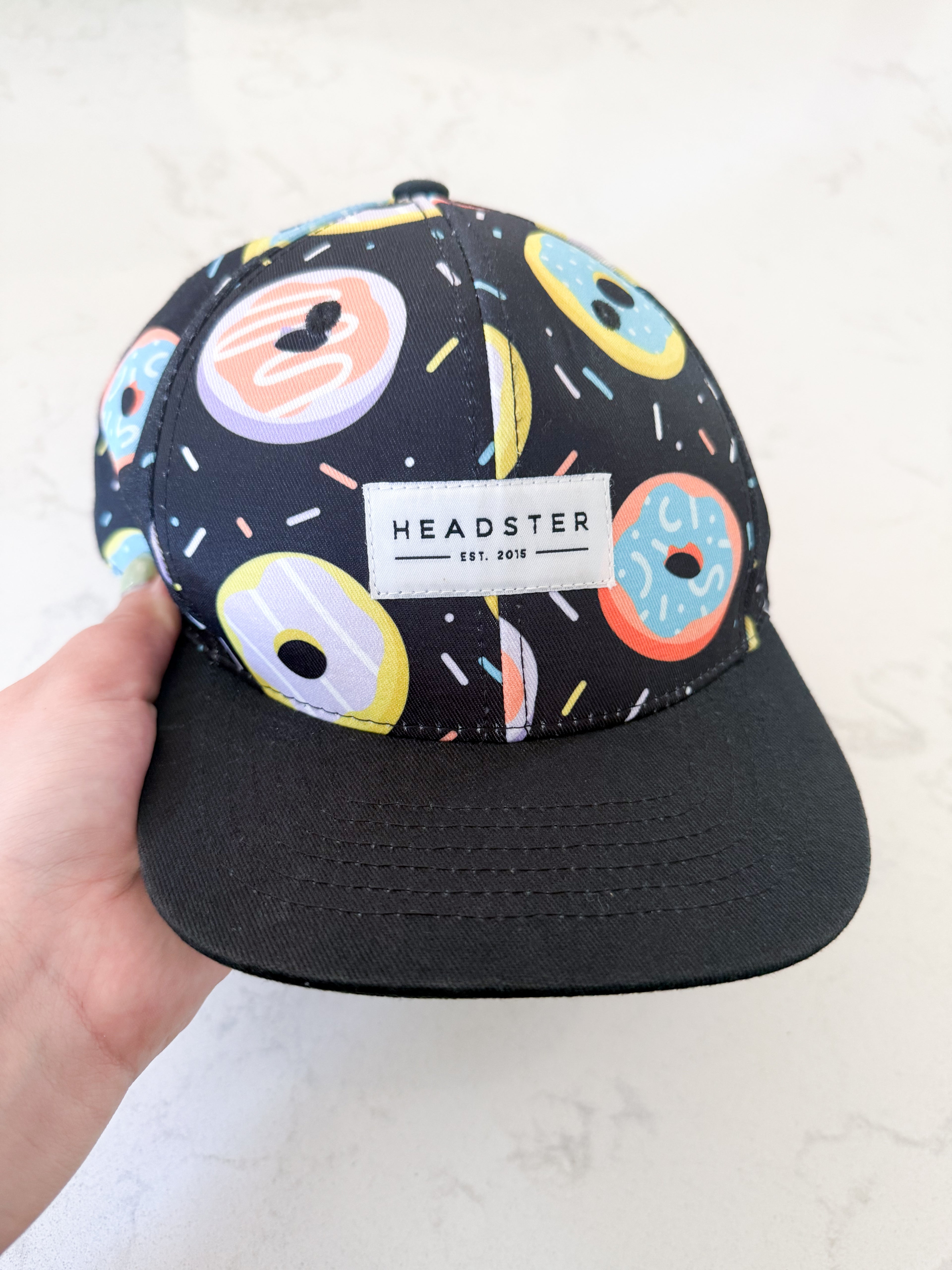 Headster- 52cm- GUC- black cap with colourful donuts