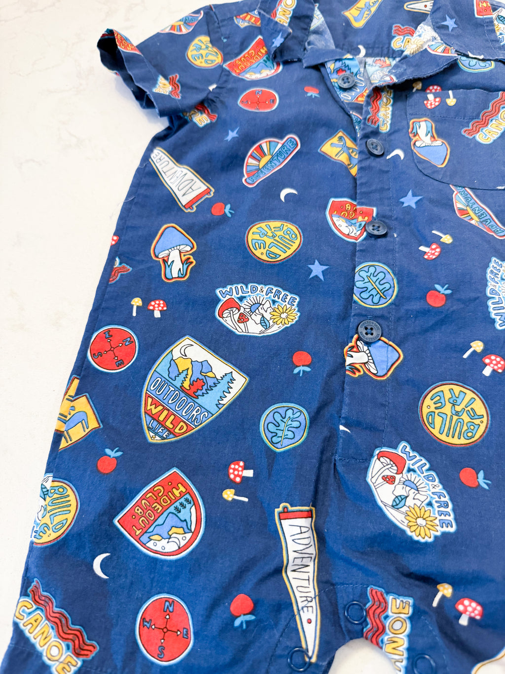 Tucker + Tate- 12-18m- GUC- blue shorts romper with outdoor badges graphic