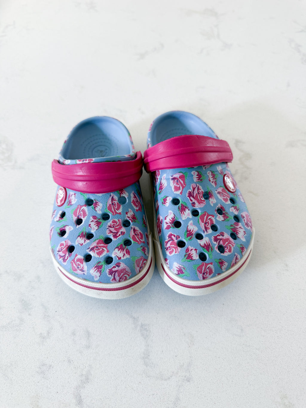 Crocs- 8/9C- GUC- light blue slip on crocs with pink florals