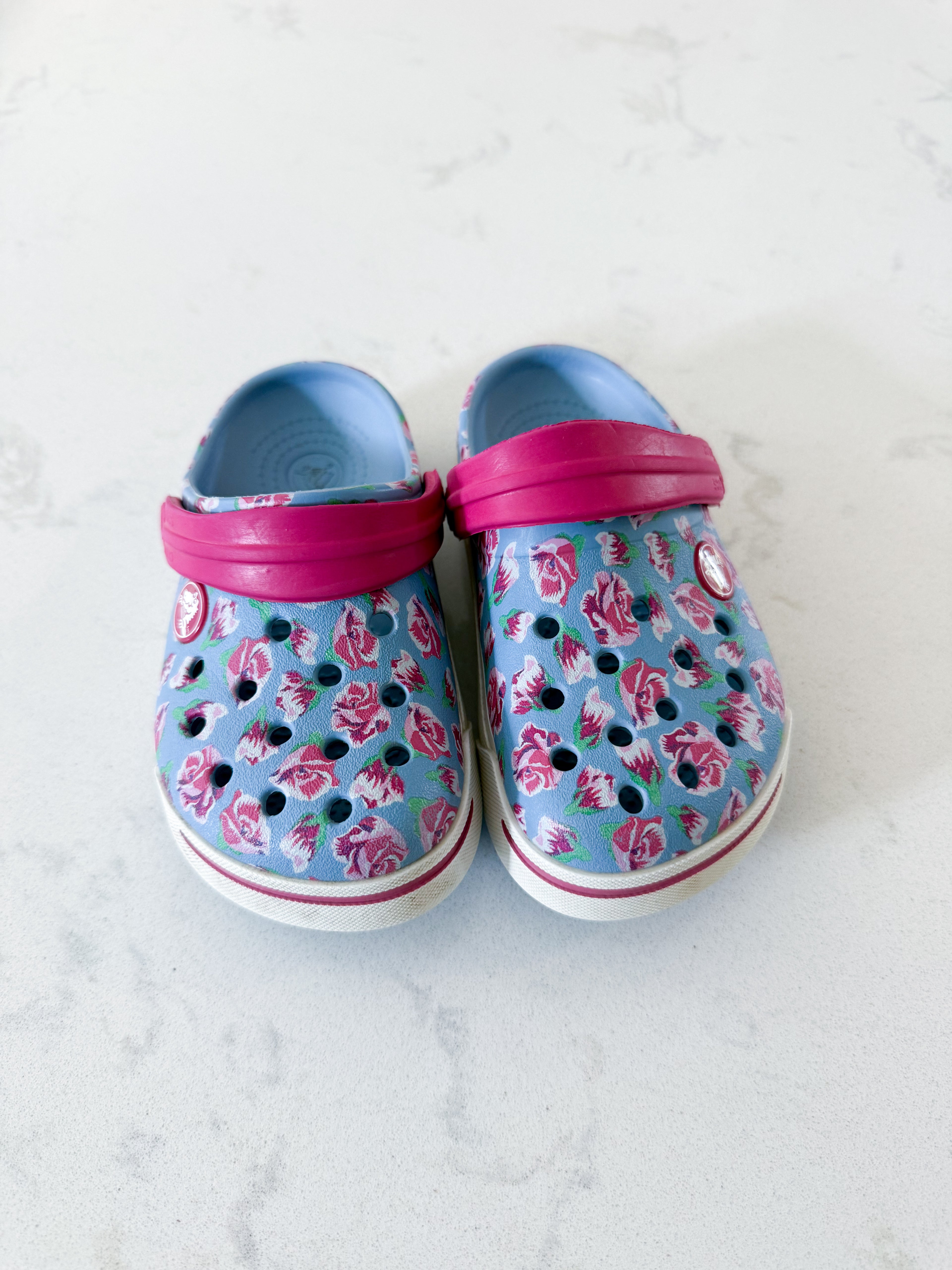 Crocs- 8/9C- GUC- light blue slip on crocs with pink florals