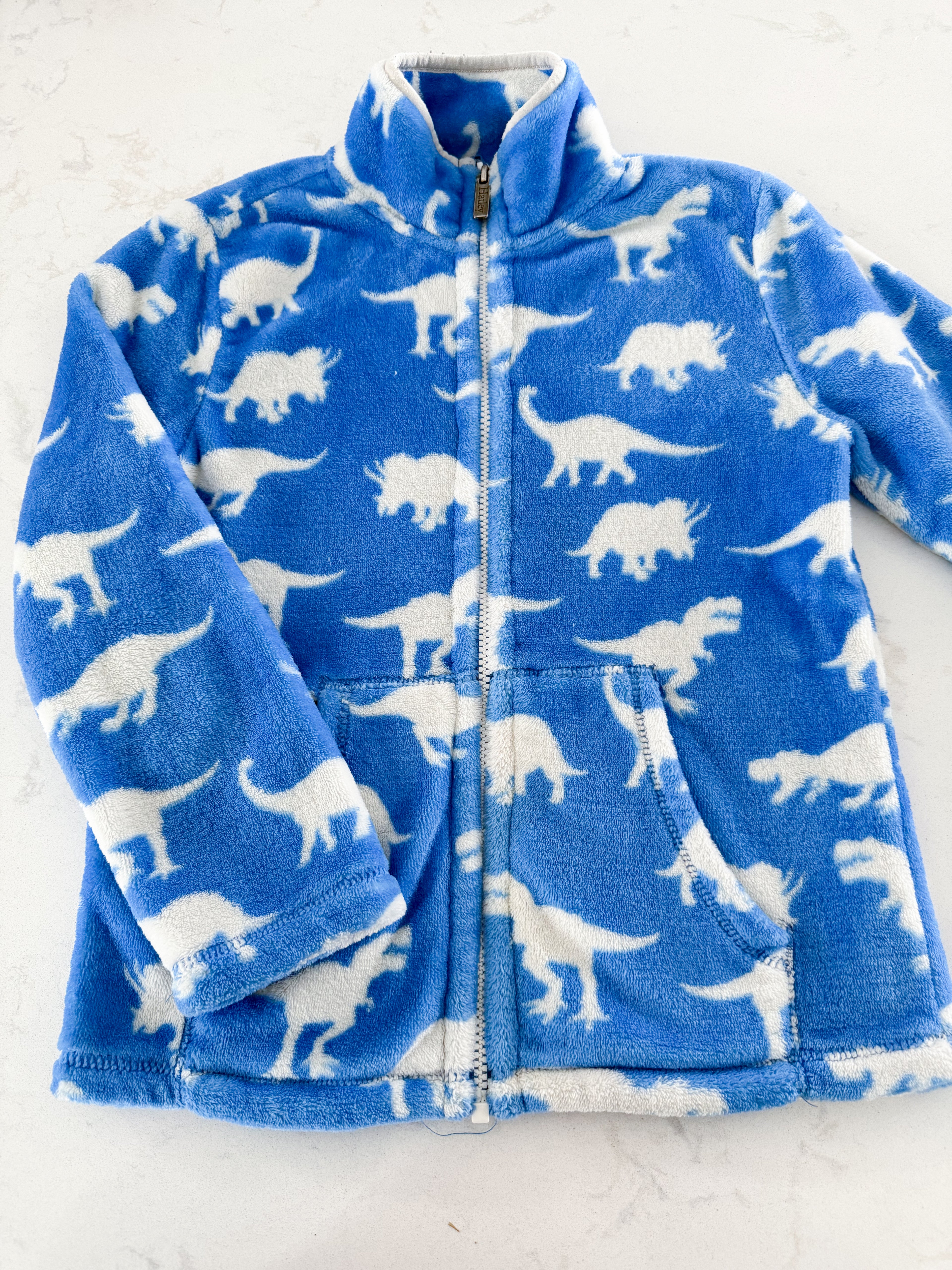 Hatley- 7Y- GUC- fuzzy blue zip up fleece with dinosaurs