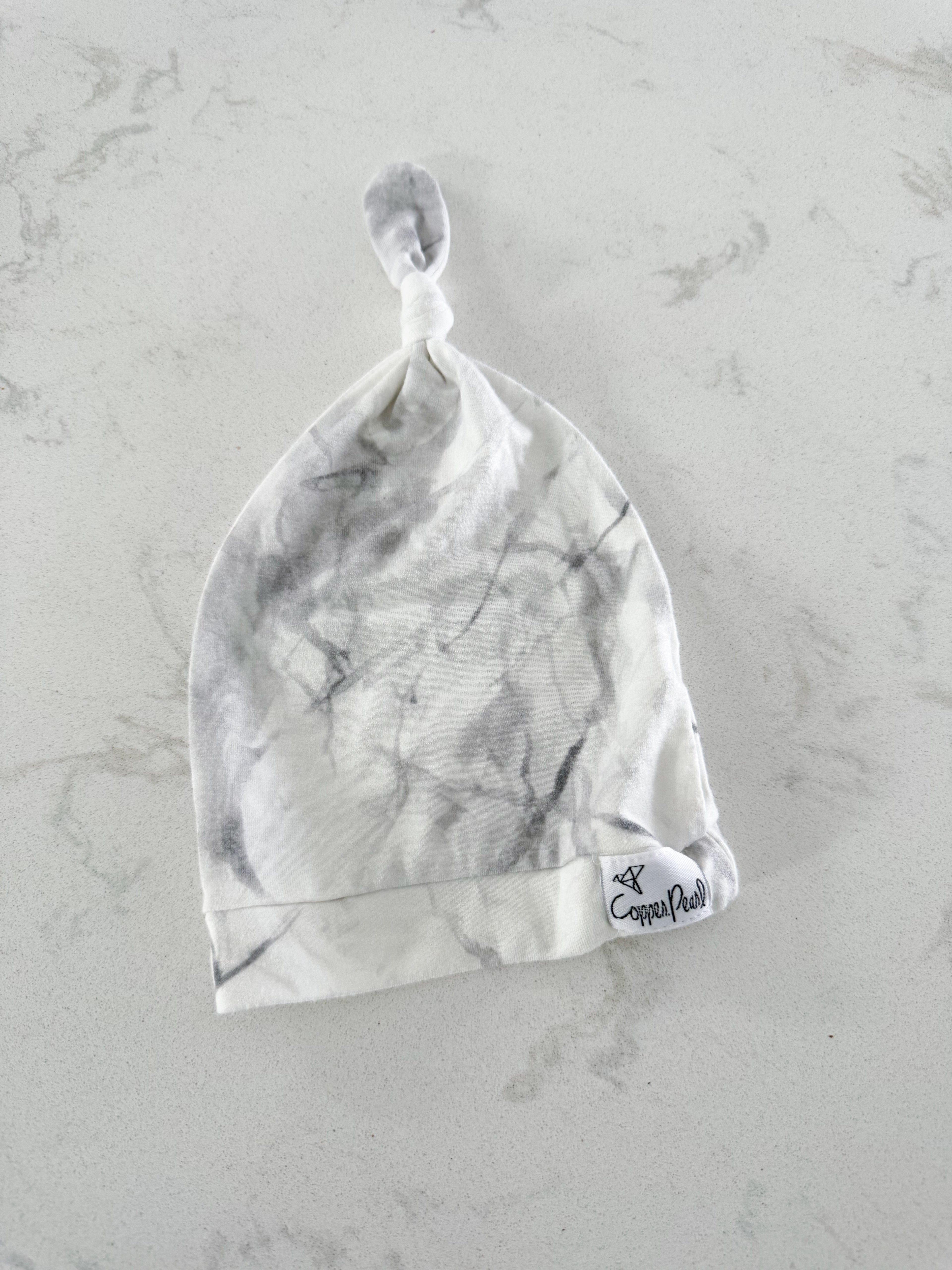 Copper Pearl- newborn hat- VGUC- bamboo like material with white marble pattern