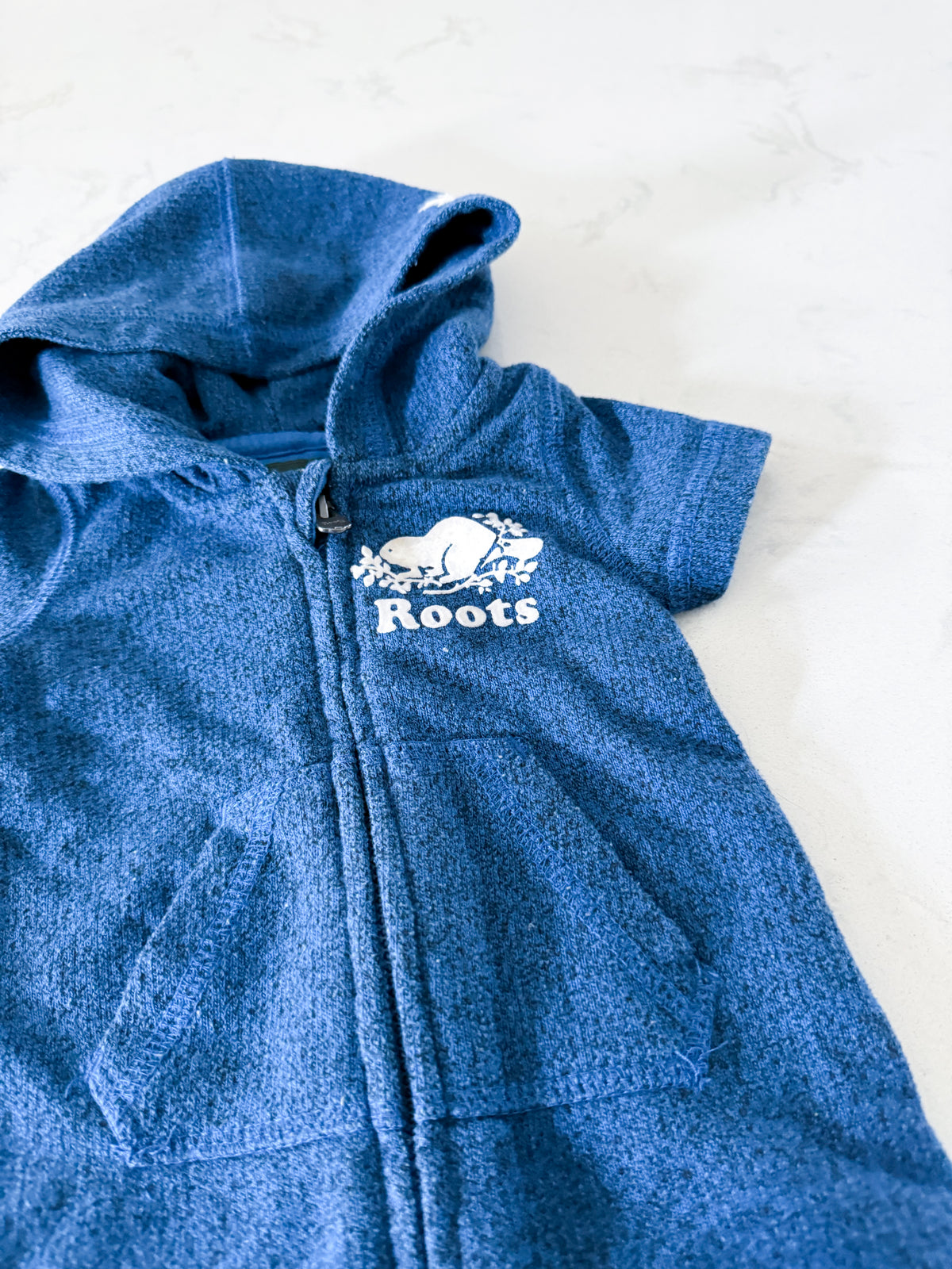 Roots- 0-3m- VGUC- medium blue short sweater romper with hood