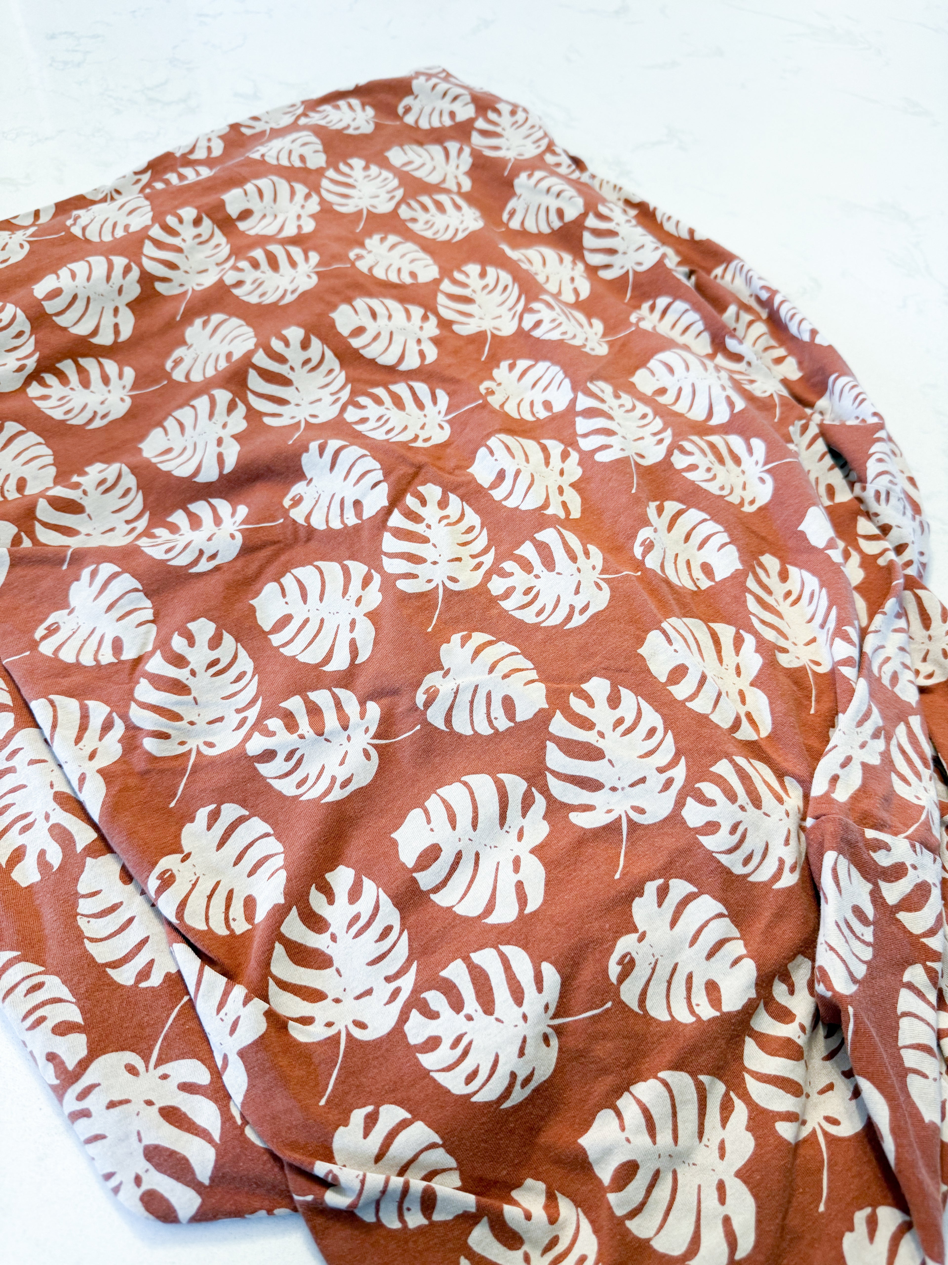 Coccoli- crib sheet- GUC- brown bamboo crib sheet with neutral tropical leaves