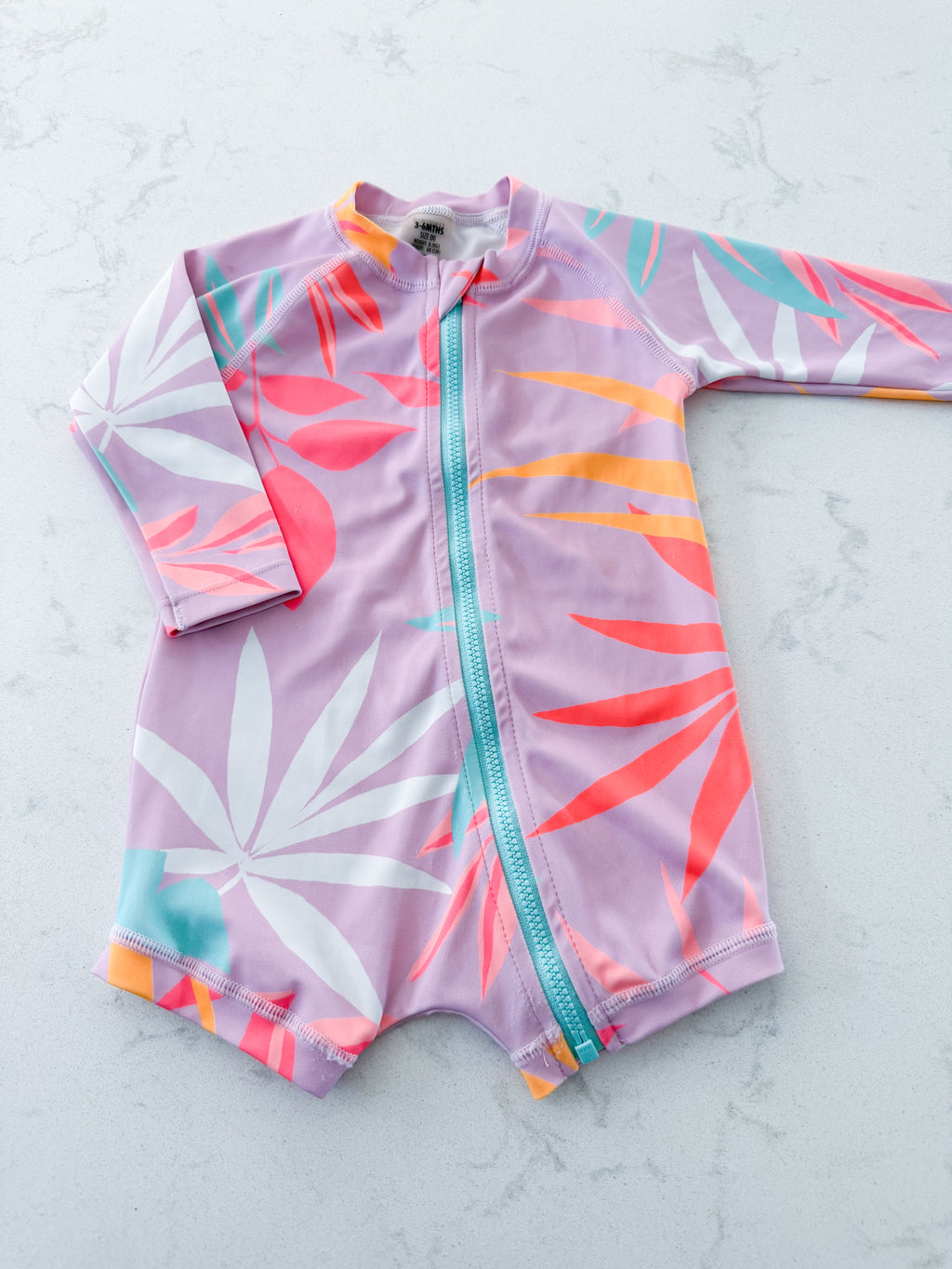 BONDS- size 00 (3-6m)- GUC- pink long sleeve swim suit with bright tropical leaves