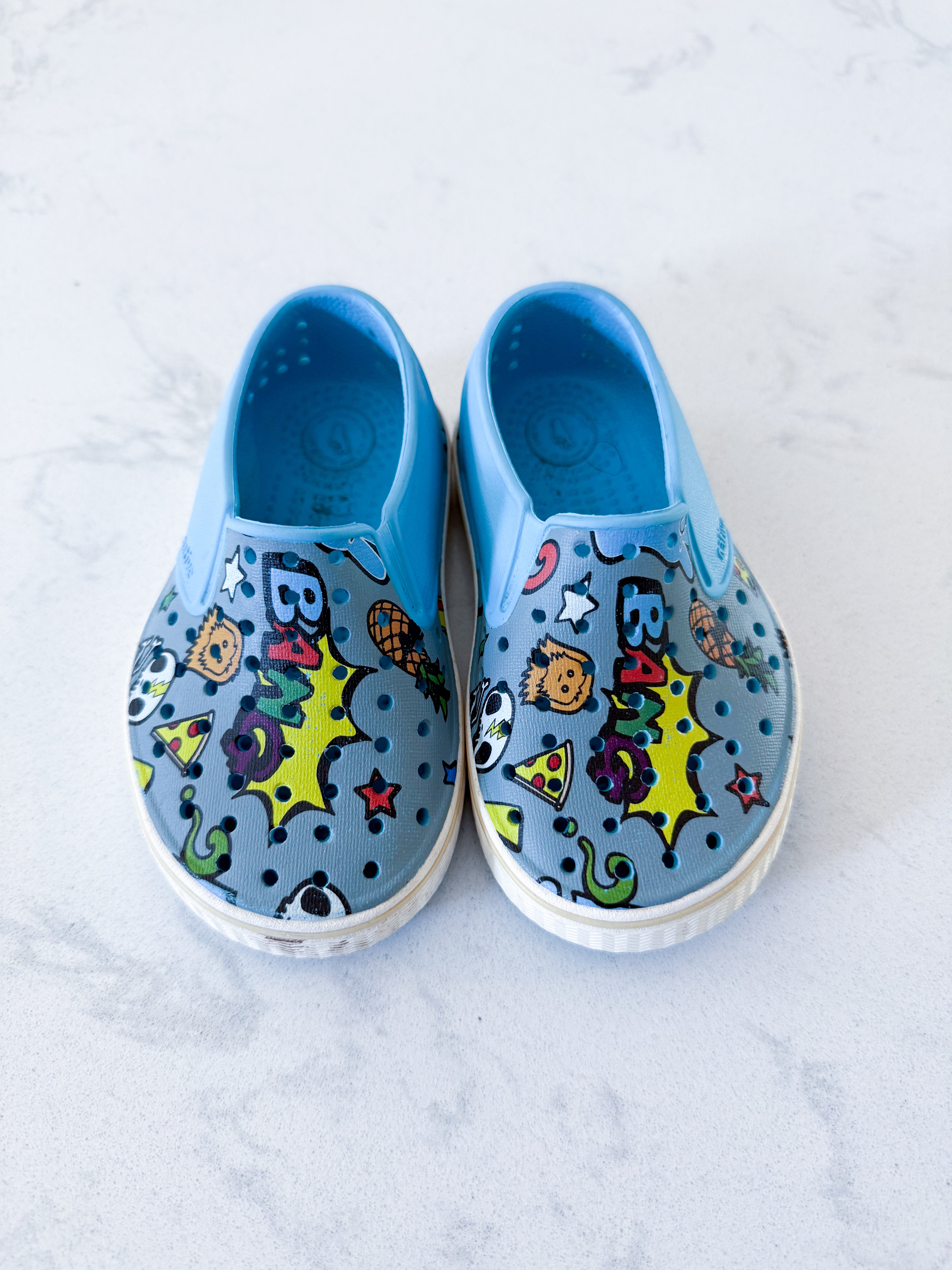 Natives- 7C- GUC- slip ons with comic graphics