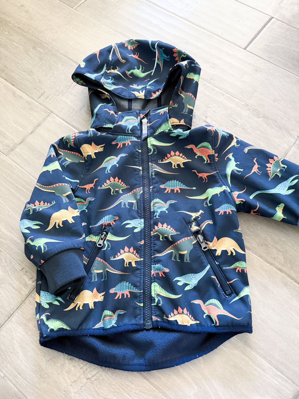H&M- 1.5-2T- VGUC- softshell navy blue fleece lined jacket with dinosaur pattern