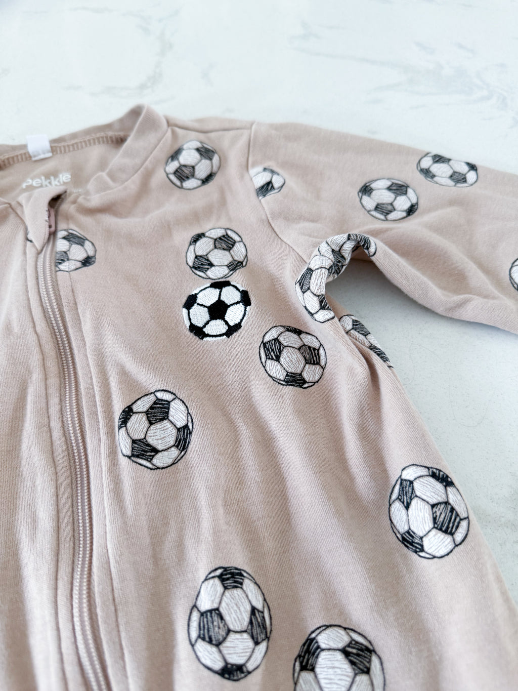 Pekkle- 24m- GUC- beige footie pajamas with embroidered soccer ball