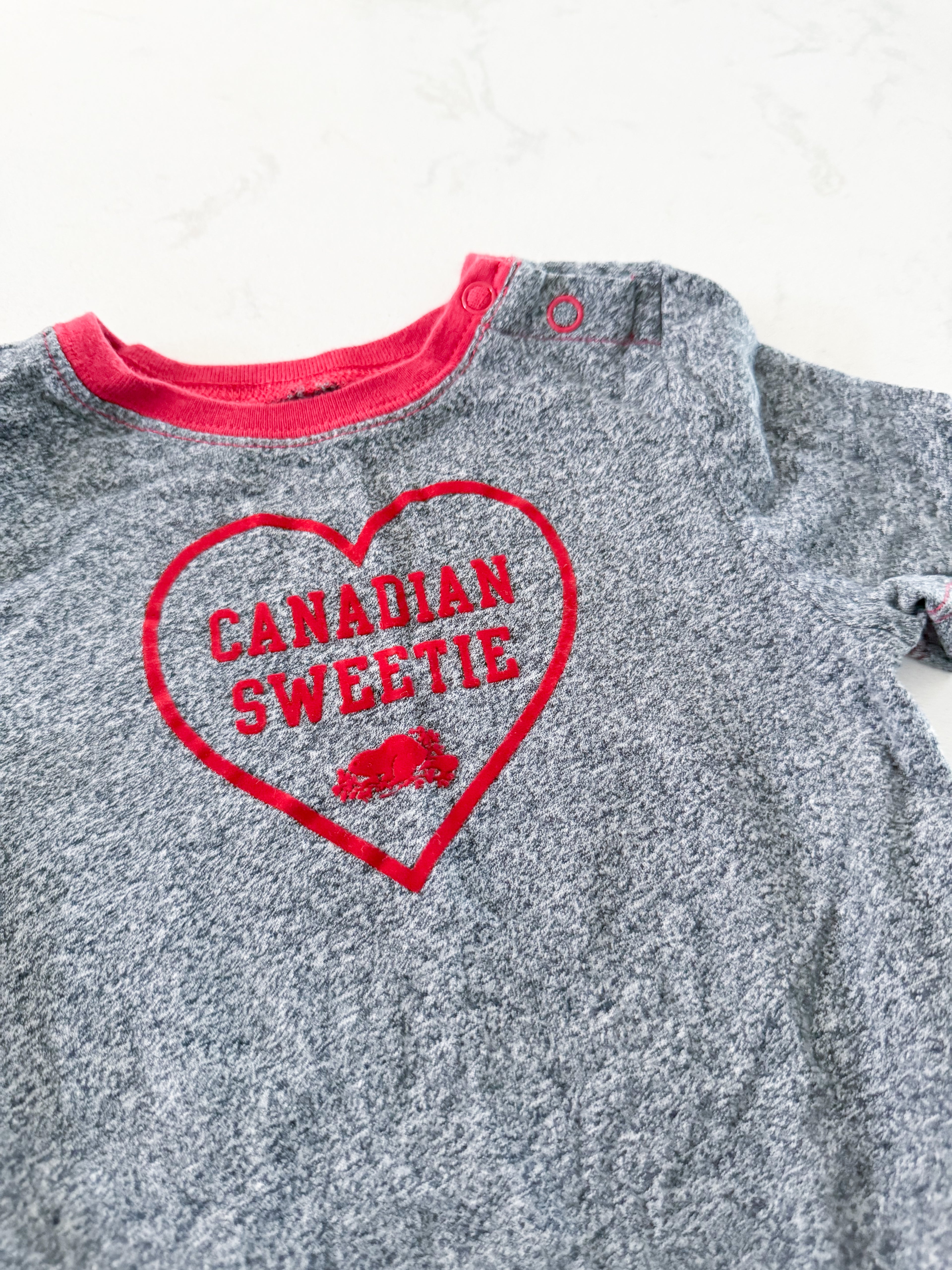 Roots- 18-24m- VGUC- grey speckled short sleeve bodysuit with Canadian sweetie on front