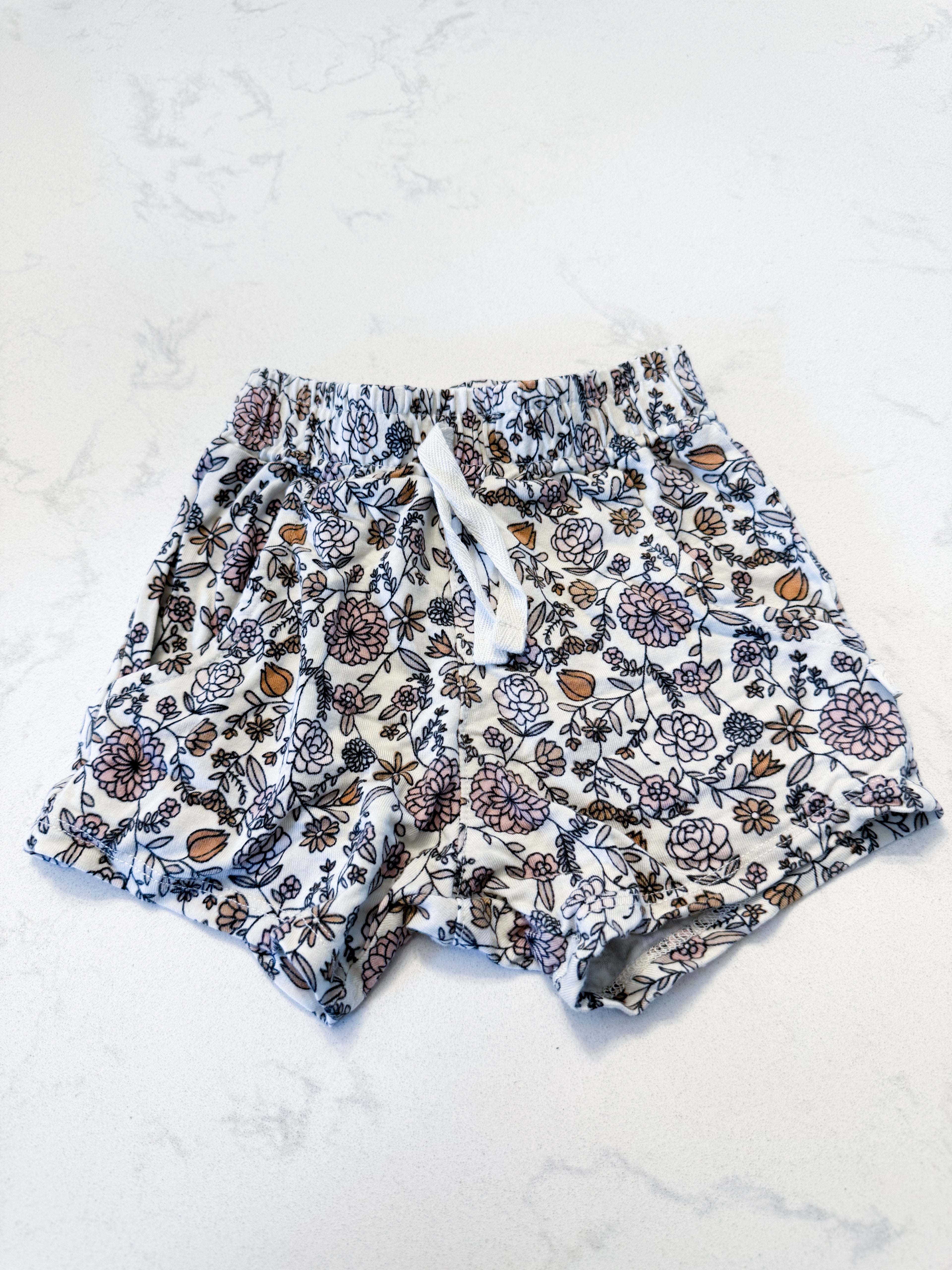 Jax and Lennon- 12-18m- GUC- cream coloured shorts with neutral floral pattern