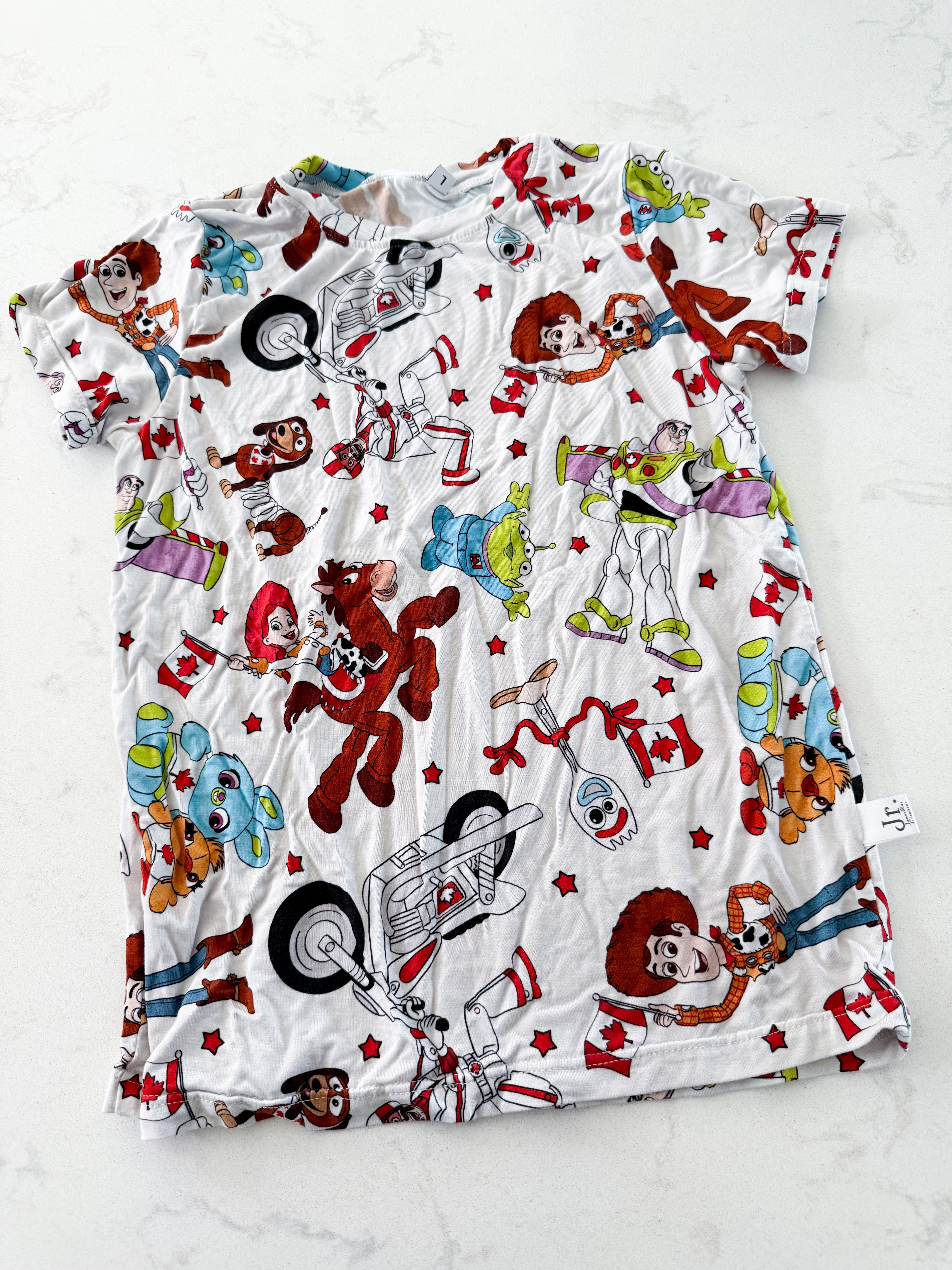 James Rae Creations- 6/7Y- VGUC- white bamboo t shirt with Toy Story Canadian characters