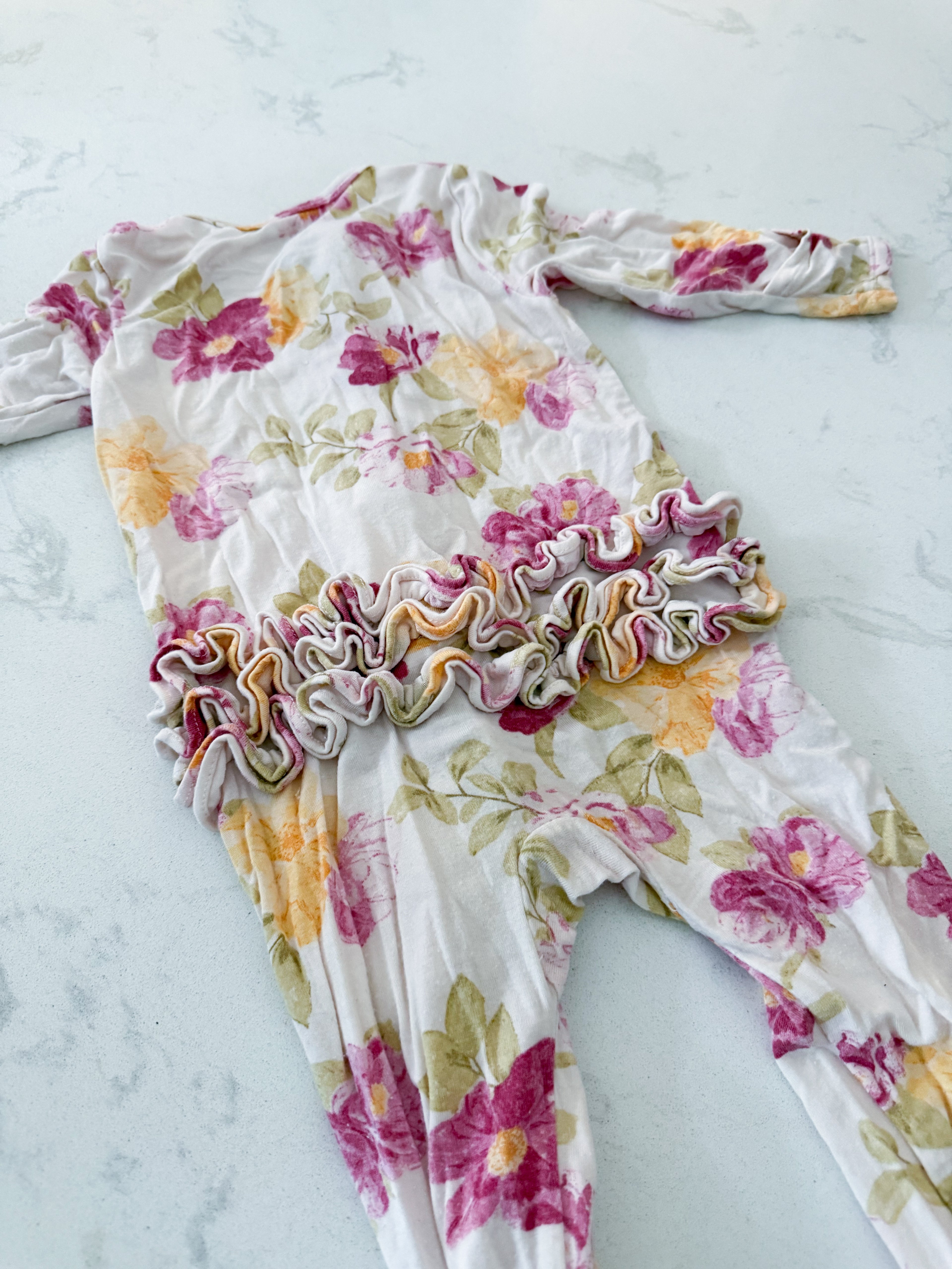 Angel Dear- 6-9m- GUC- cream coloured bamboo jammies with pink yellow florals and ruffle bum