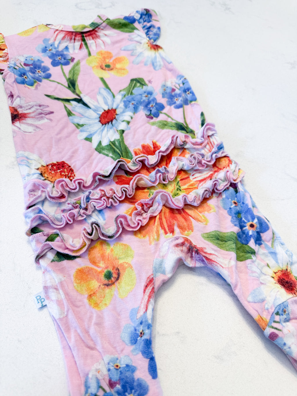 Posh Peanut- 0-3m- VGUC- light pink short sleeve romper with bright florals and ruffle bum