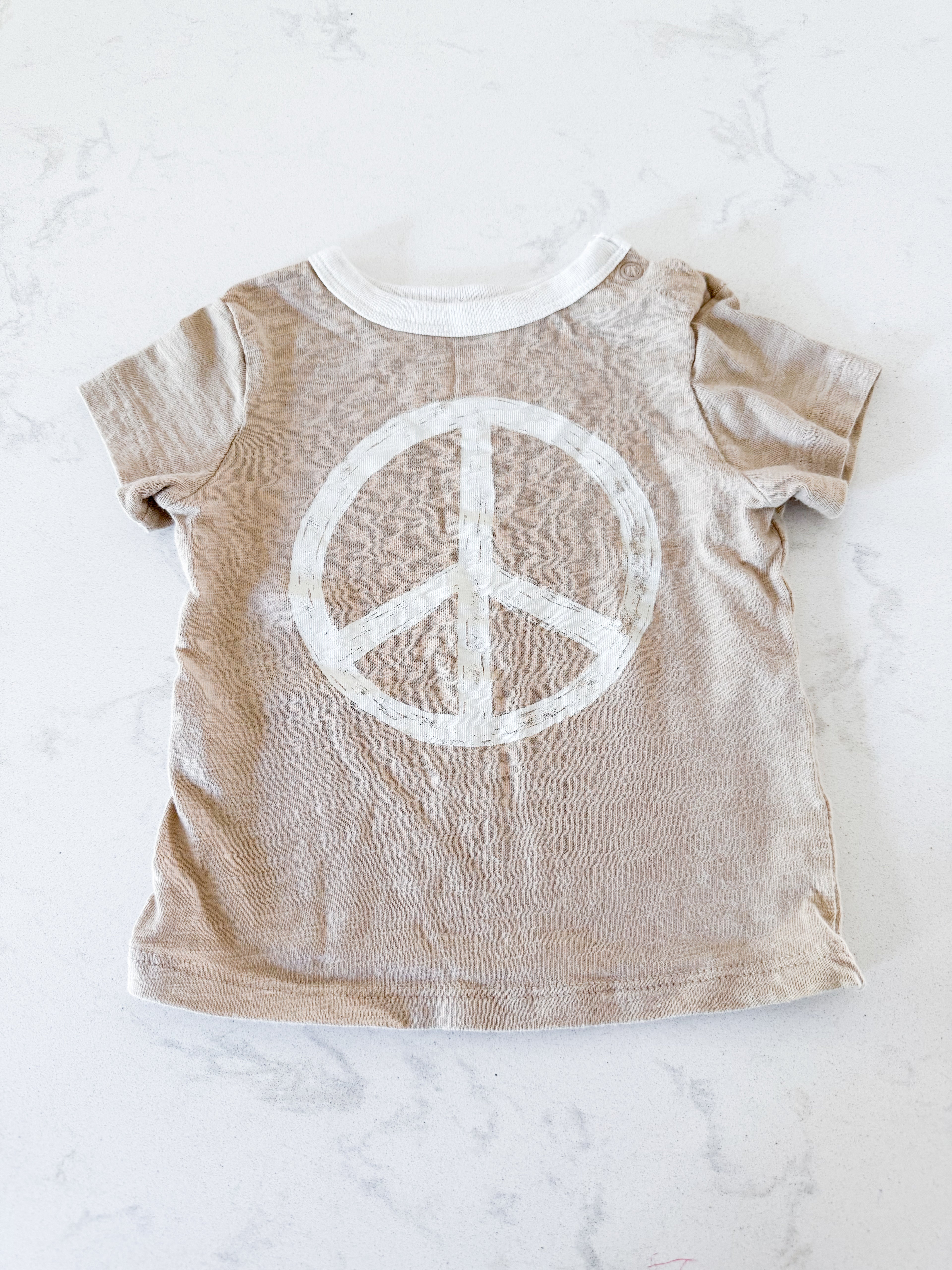 Little Co (Lauren Conrad)- fits 3-6m- GUC- beige t shirt with cream colored peace sign