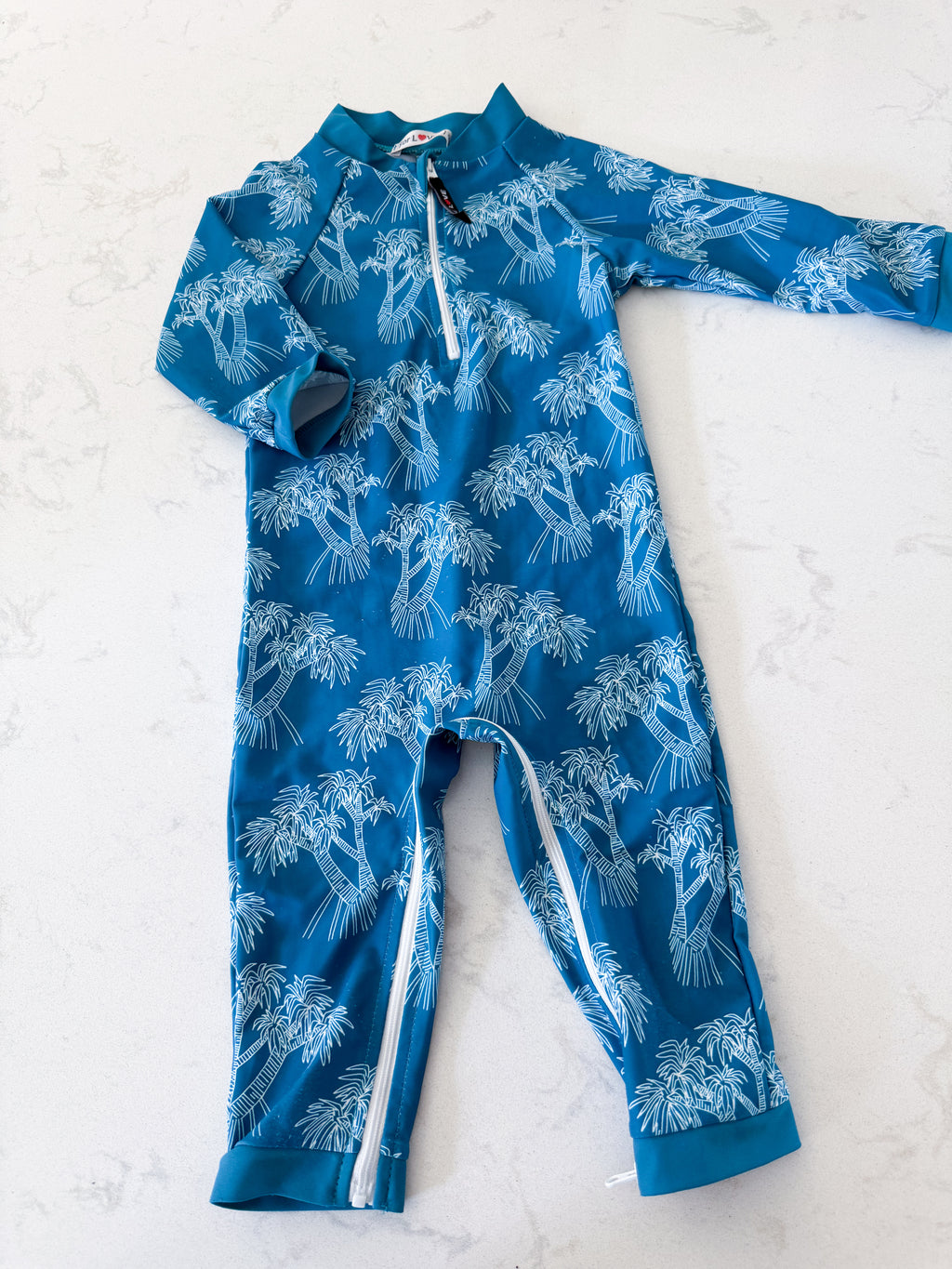 For Love- 12-18m- GUC- blue one piece long sleeve swim suit with white palm trees