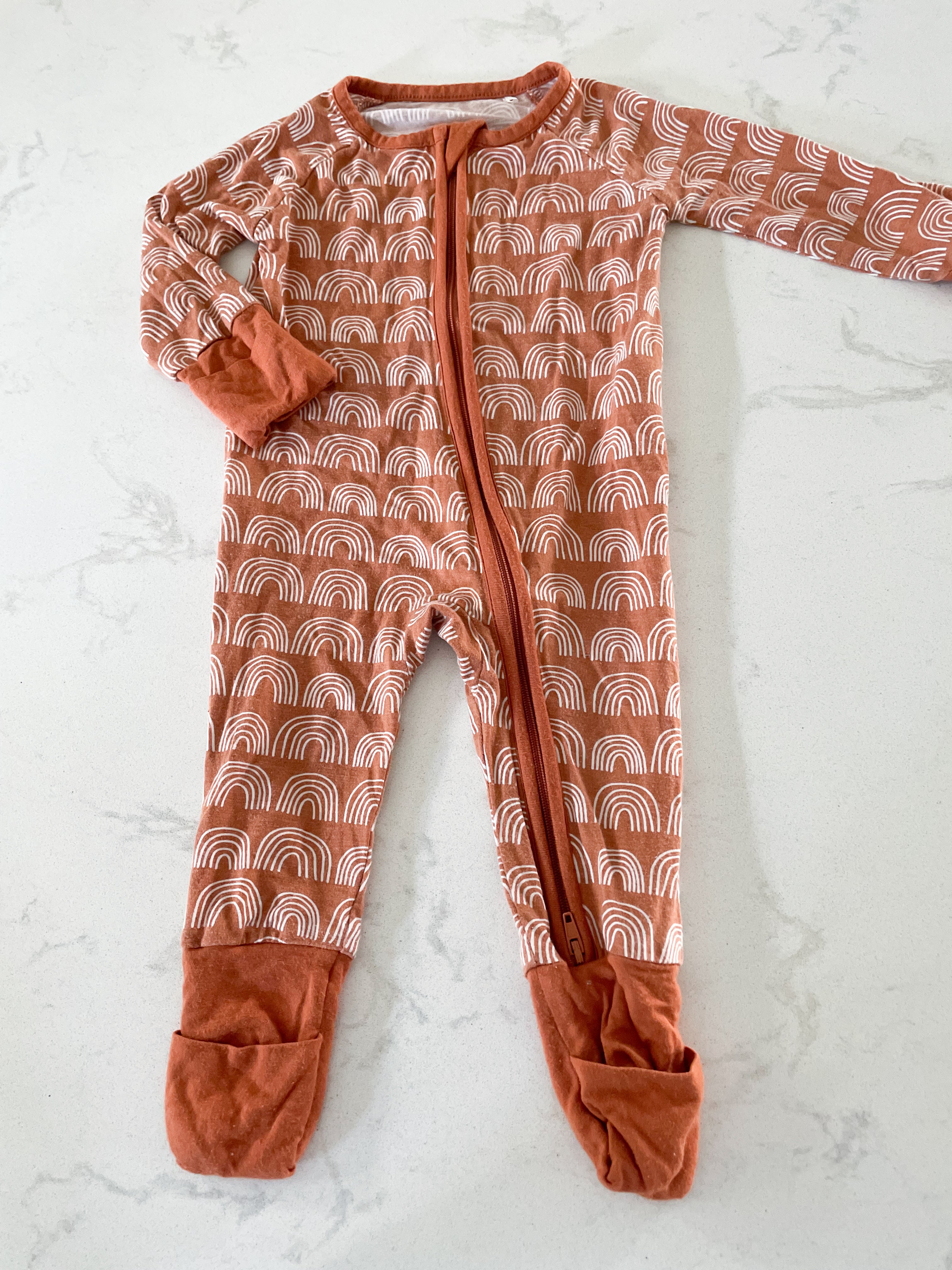 Miozing- 0-3 months- rust coloured rainbow bamboo sleeper with fold over feet and hands