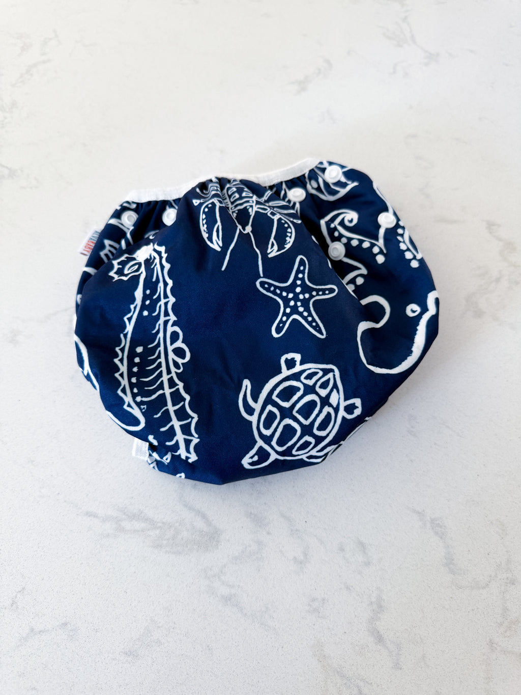 Alva Baby- adjustable- swim diaper with navy blue swim diaper with White Sea creature pattern