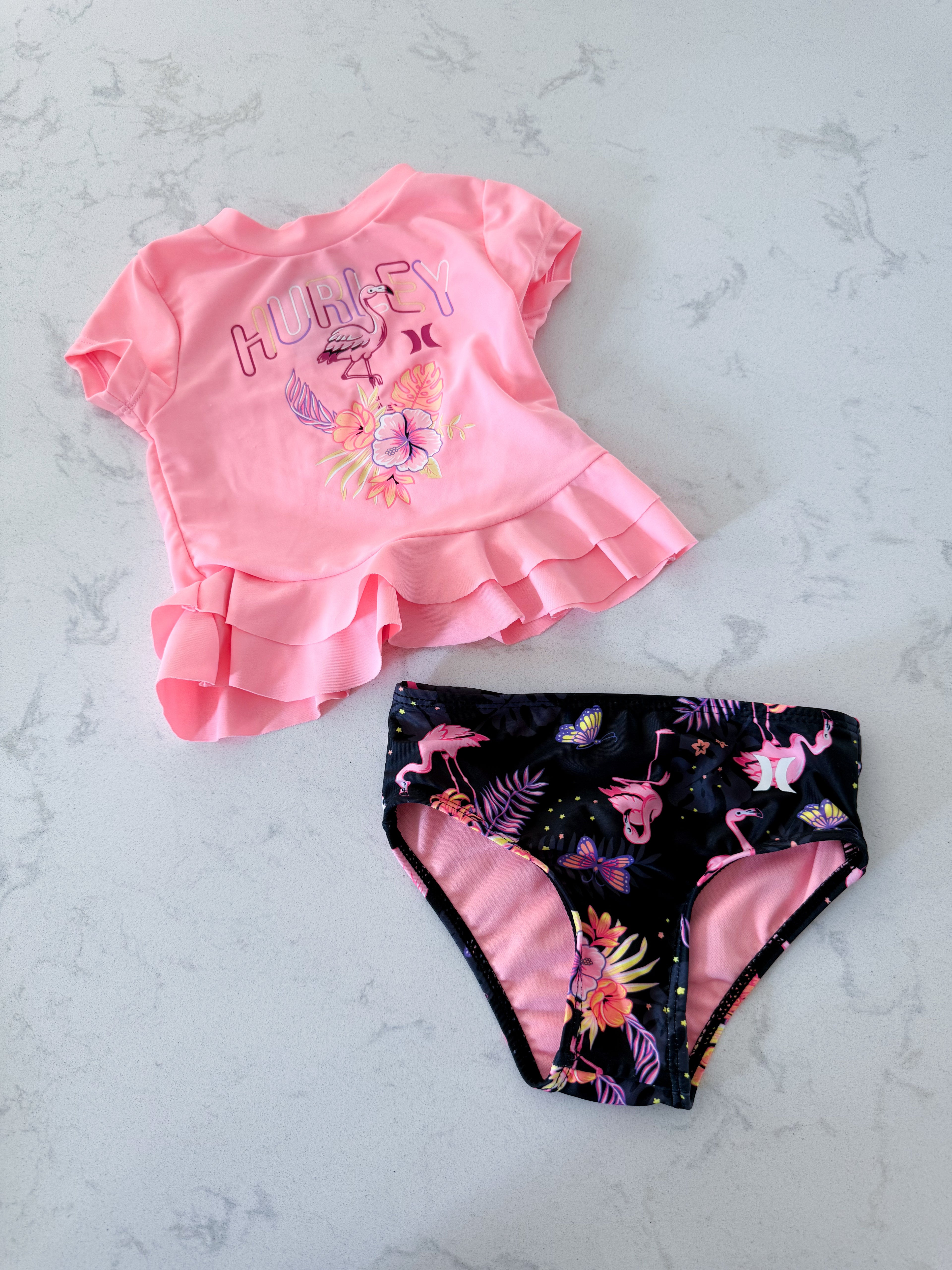 Hurley- 12m- VGUC- two piece neon pink swim suit with black bottoms and flamingos