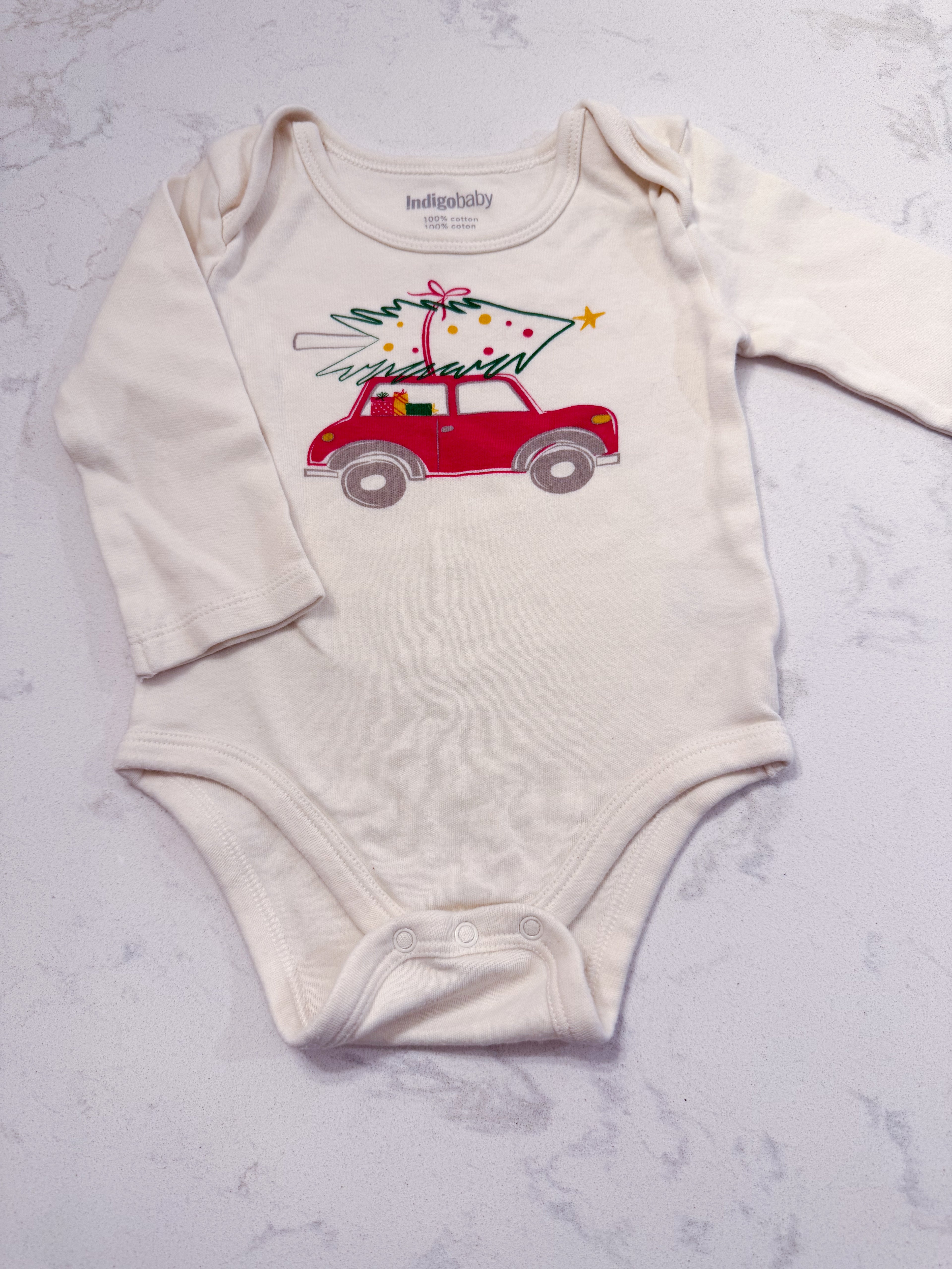 Indigo Baby- 6-12m- GUC- cream coloured long sleeve bodysuit with red car carrying Christmas tree