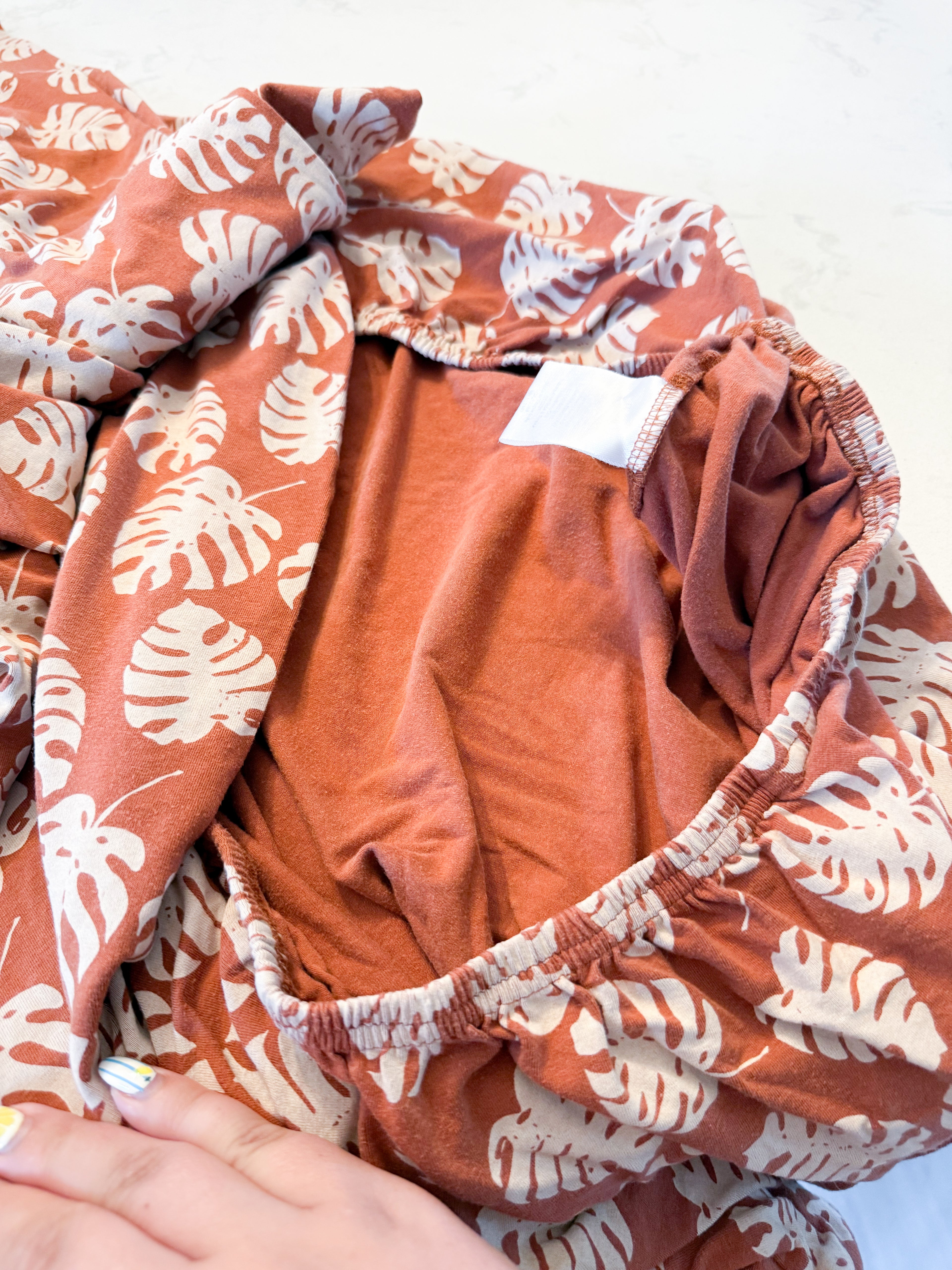 Coccoli- crib sheet- GUC- brown bamboo crib sheet with neutral tropical leaves