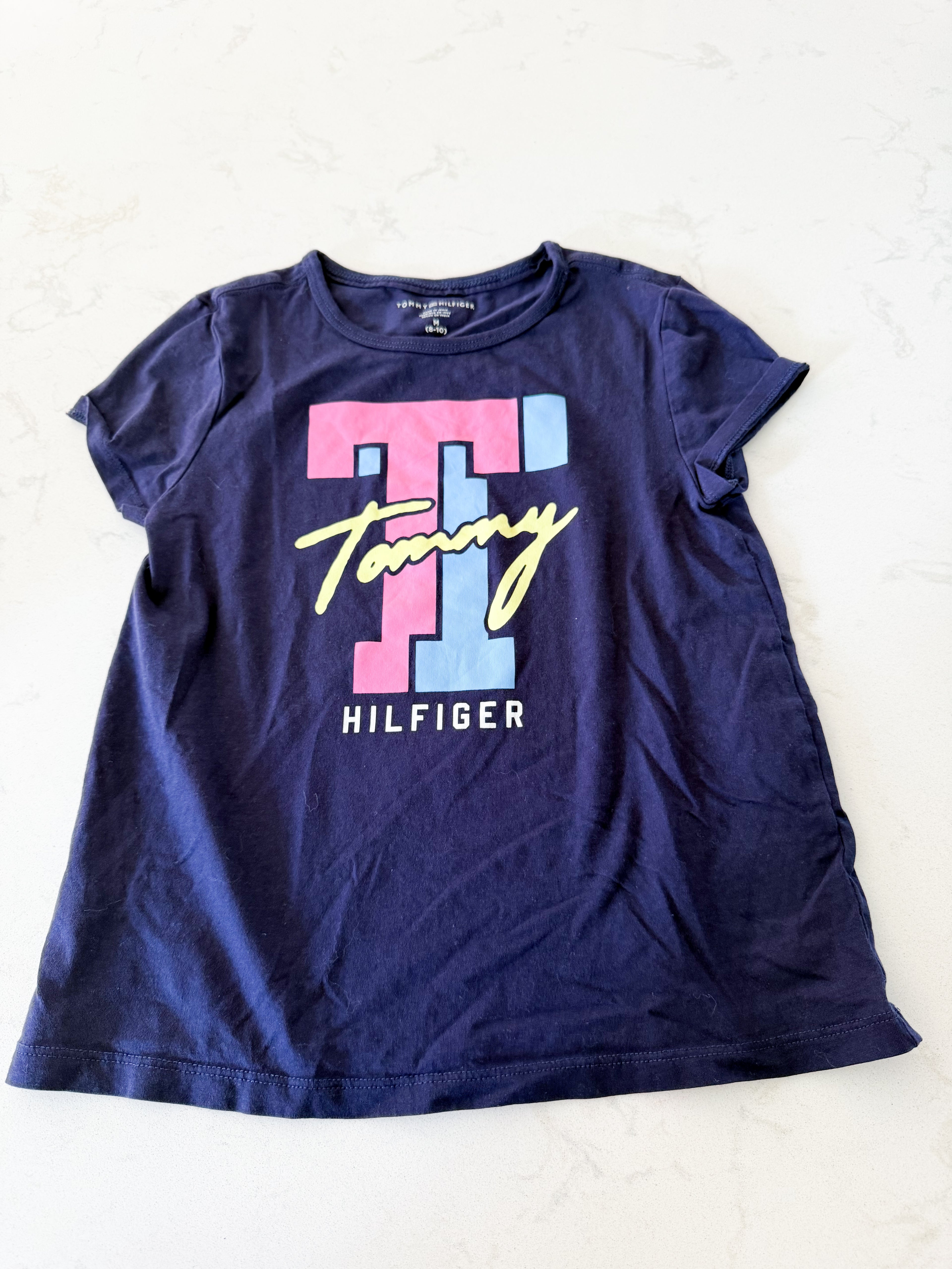 Tommy Hilfiger- M (fits 7/8Y)- VGUC- navy blue t shirt with pink blue and yellow logo