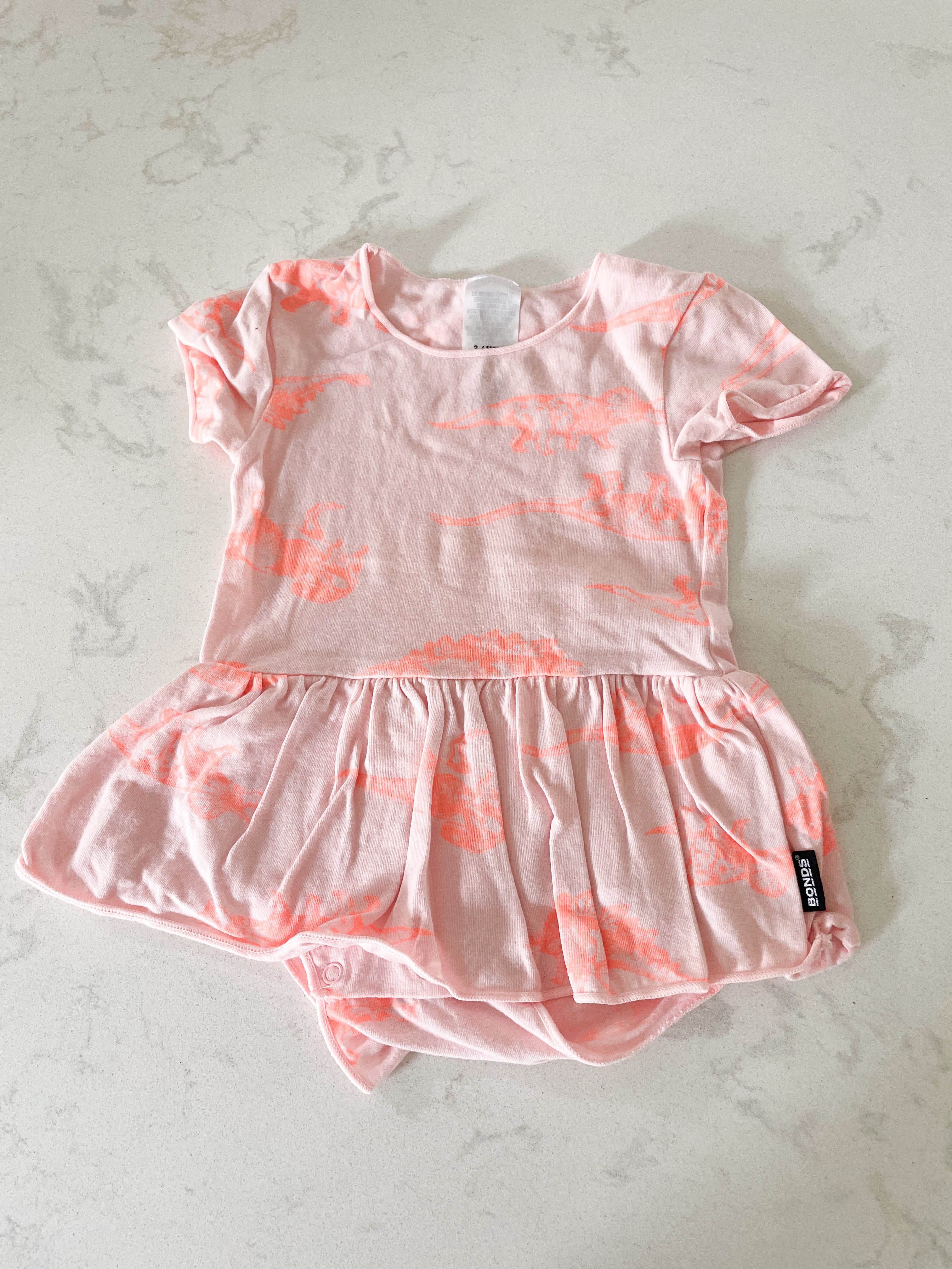 BONDS- size 00 (3-6 months)- light pink with neon dinos
