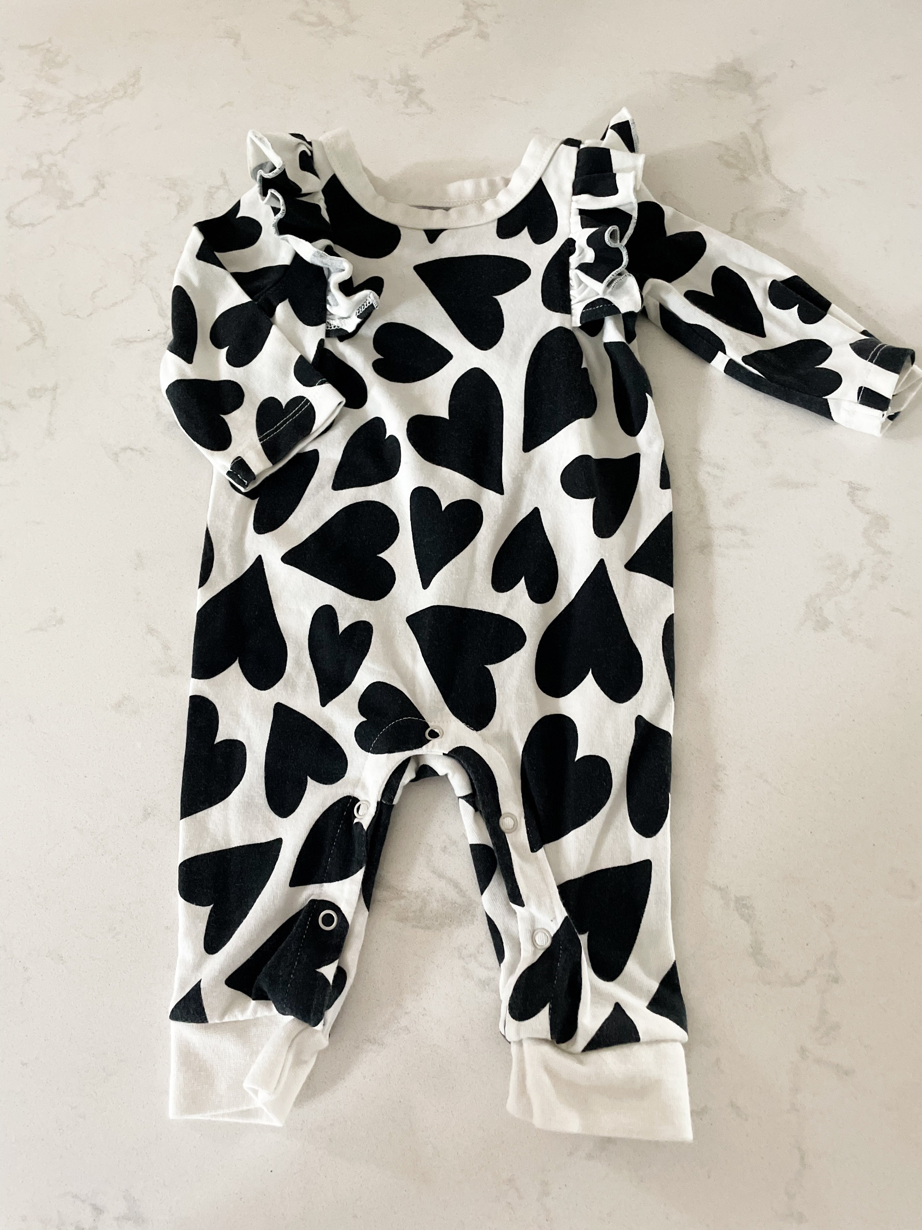 Cat and Jack- 0-3 months- long sleeve one piece ruffle romper with black hearts
