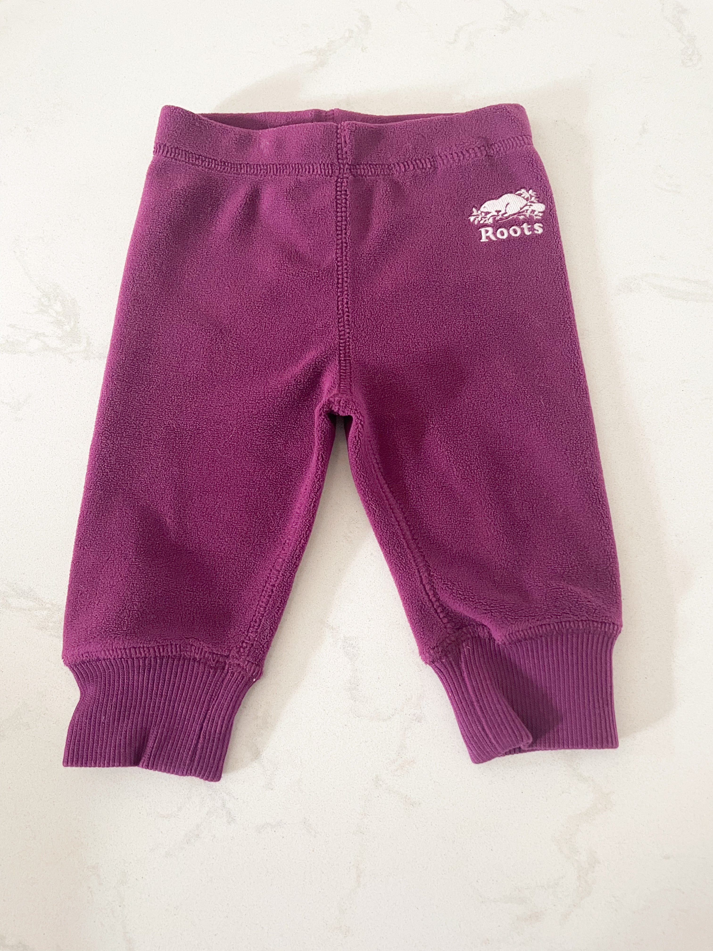 Roots- 3-6 months- purple fleece pants with white logo
