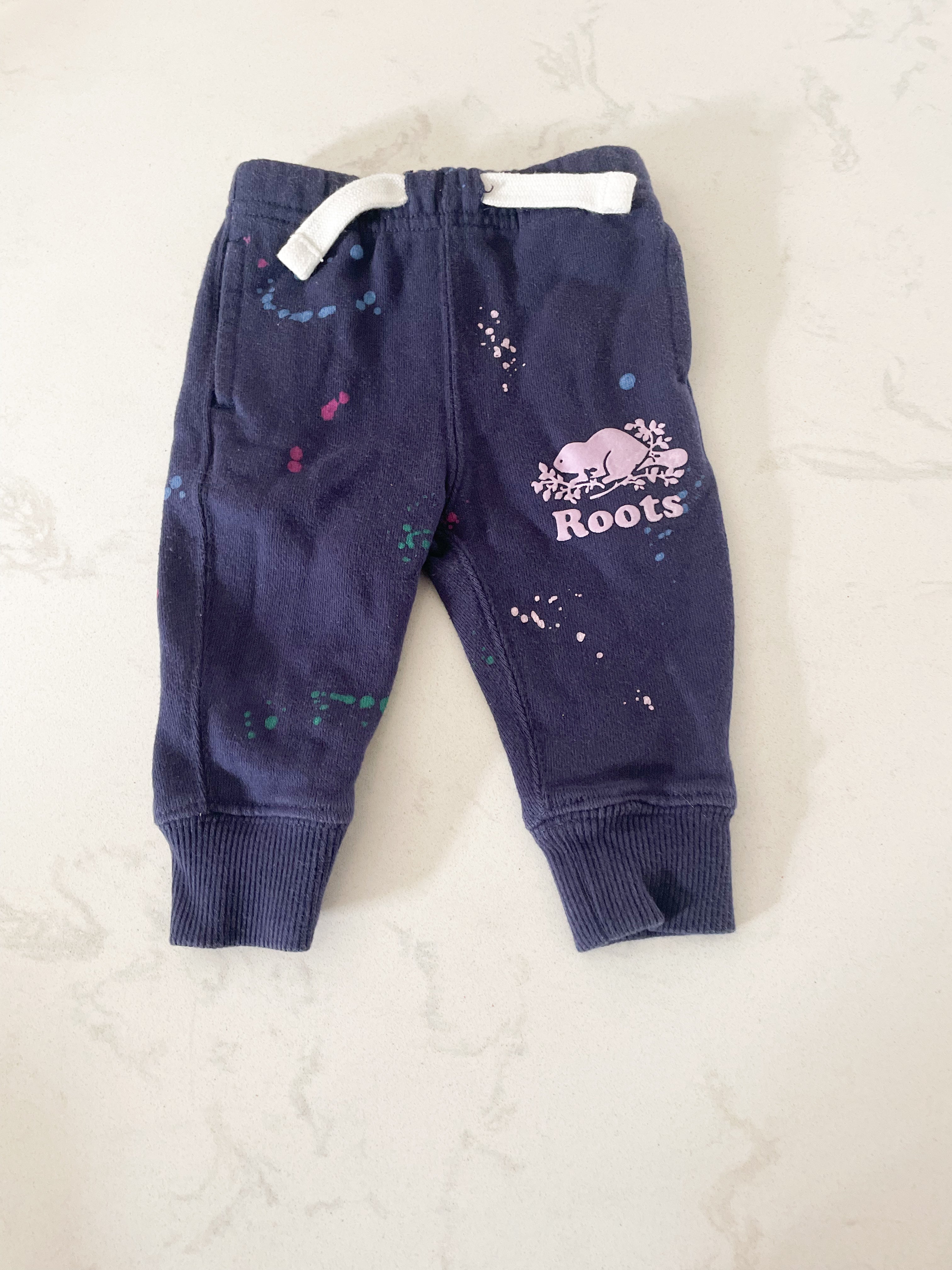 Roots- 0-3 months- dark purple sweat pants with paint specks