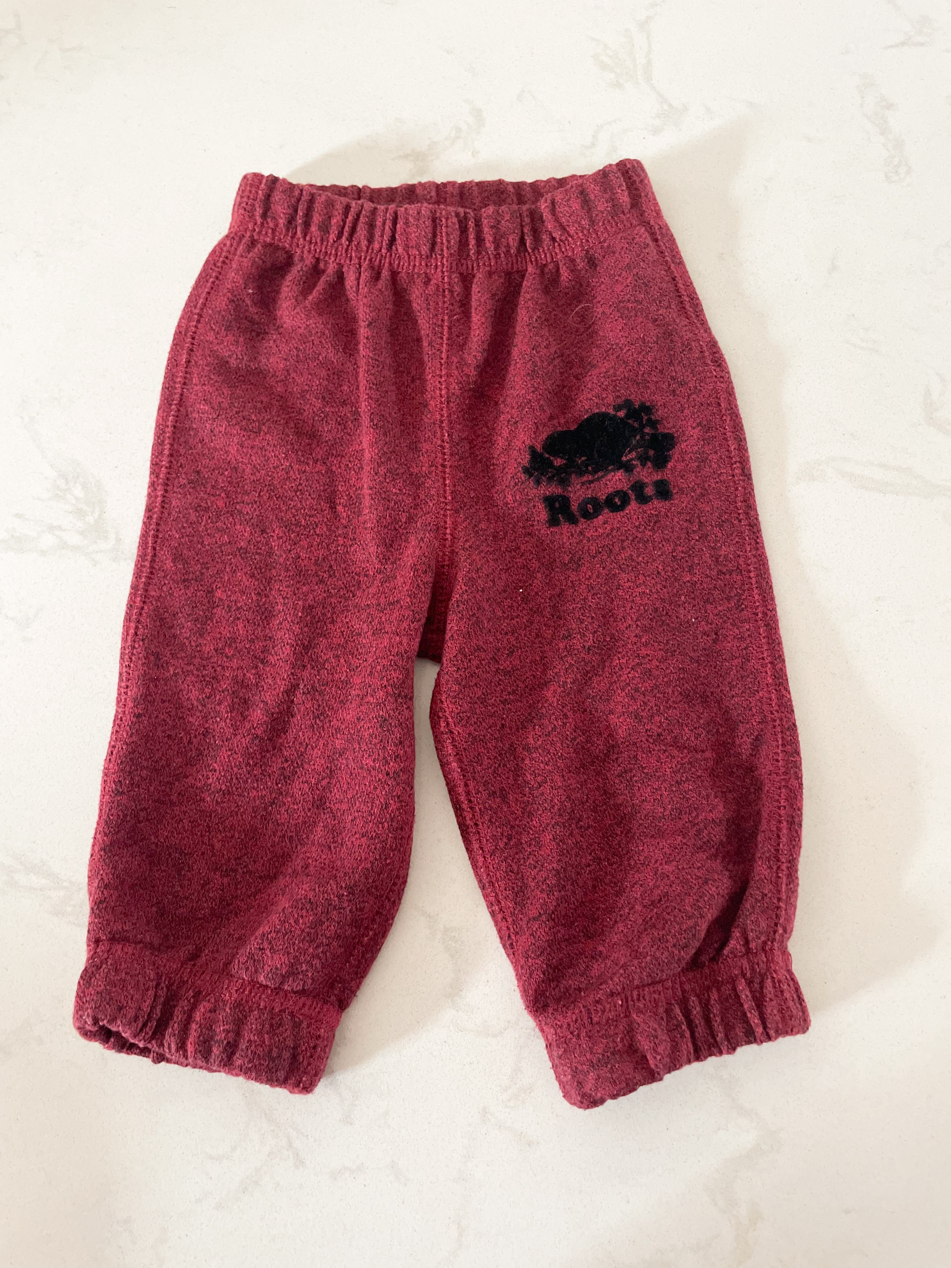 Roots- 3-6 months- red sweat pants with black logo